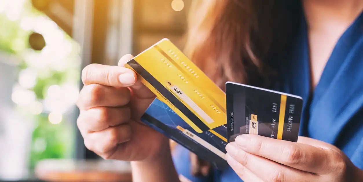 A woman with multiple credit cards needing to consolidate credit card debt. A woman with multiple credit cards needing to consolidate credit card debt.