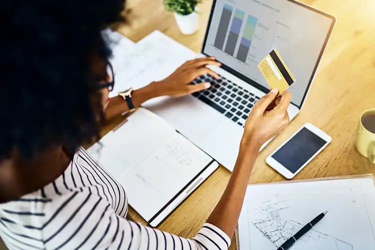 A woman managing her bills with some manual payments and some automatic payments.