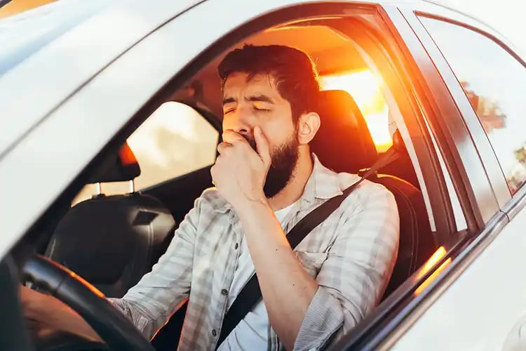 A man is tired from driving to work and should move closer to his new job.