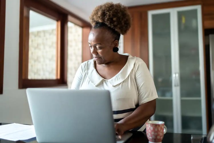 A Baby Boomer using a laptop for online banking.