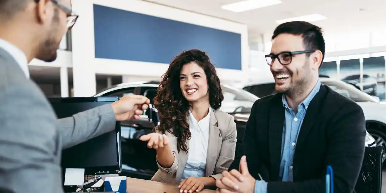 A couple purchasing a car after saving up instead of taking out an auto loan.