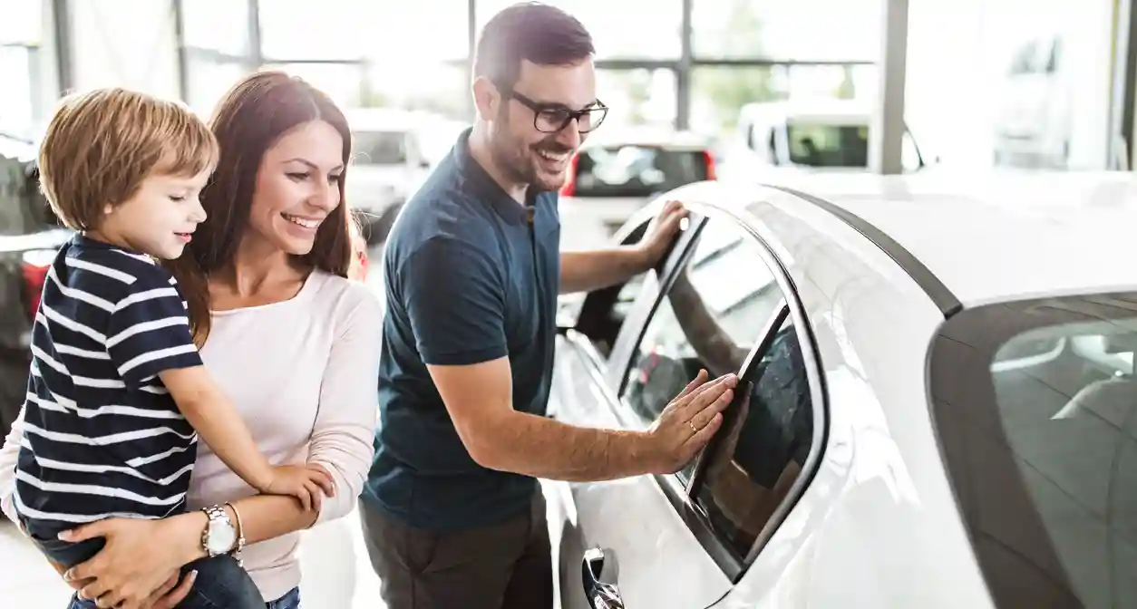 A family has gone to shop for a car and found one. A family has gone to shop for a car and found one.