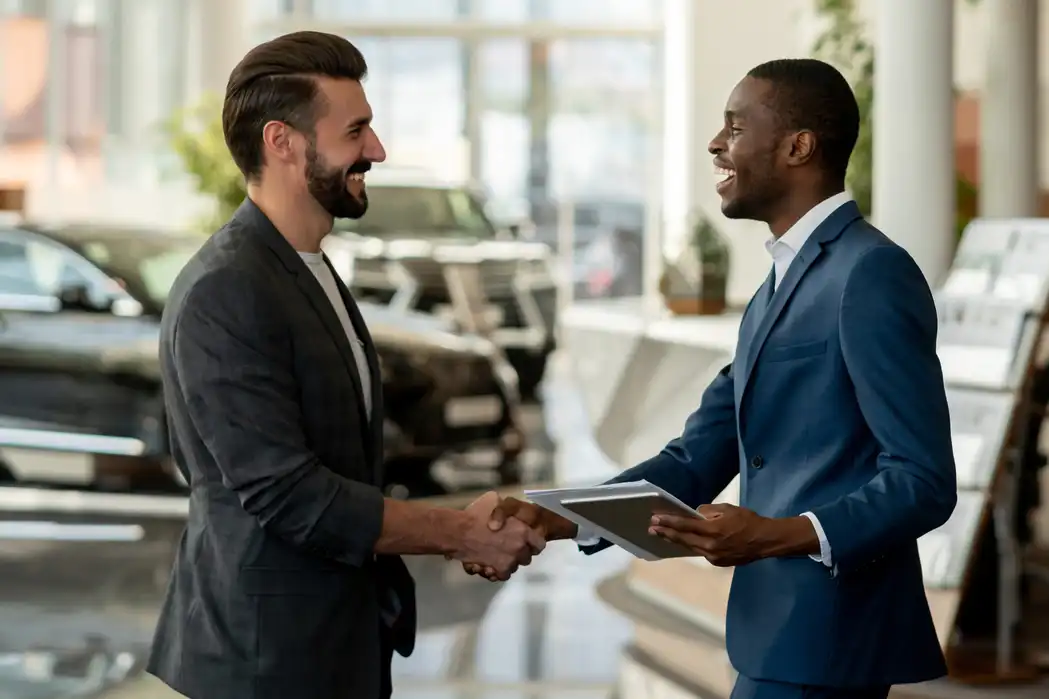 A salesperson successfully helping a customer shop for a car.