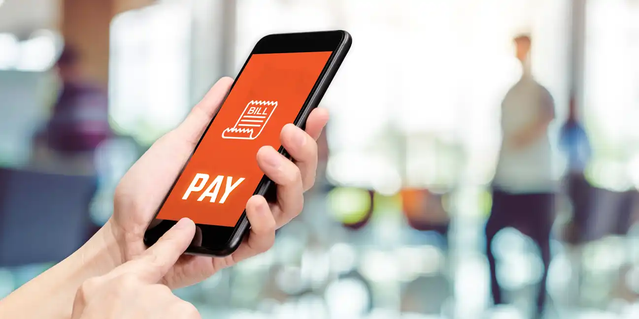 An unrecognizable person checking on automatic payments. An unrecognizable person checking on automatic payments.