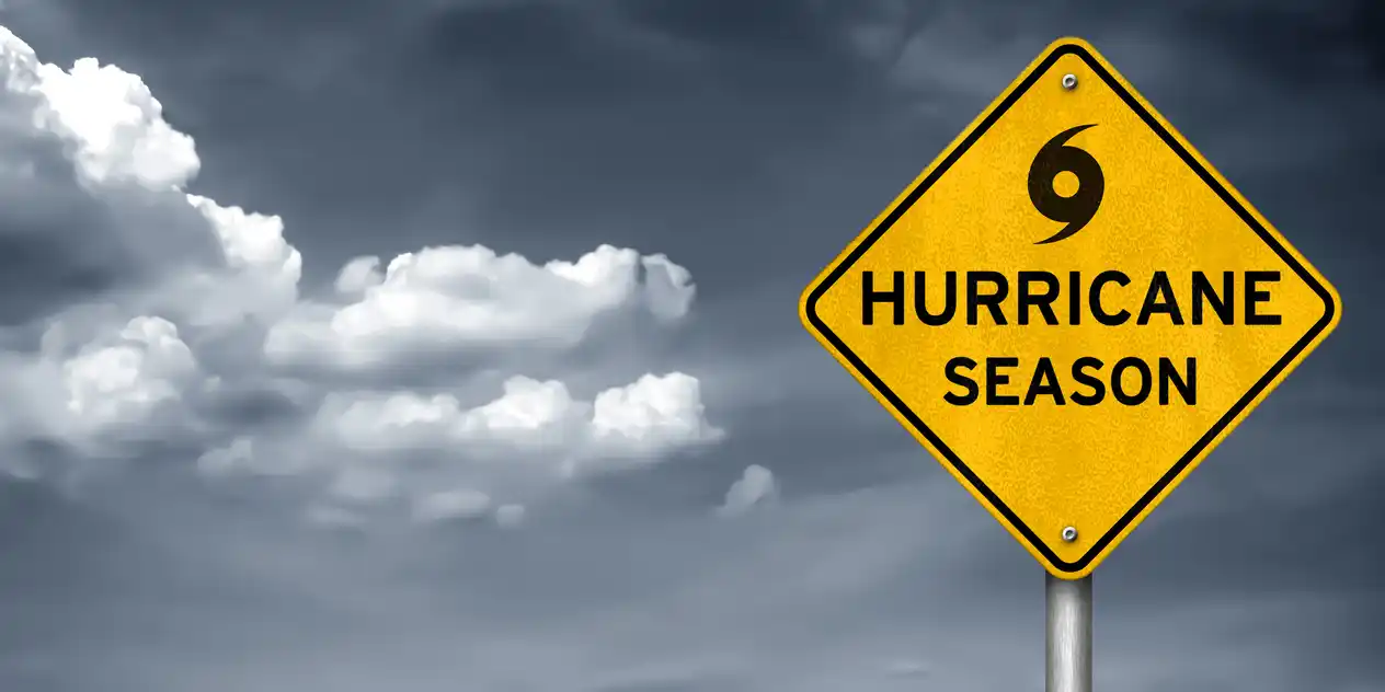 A yellow sign in front of a stormy backdrop indicating hurricane season in Houston. A yellow sign in front of a stormy backdrop indicating hurricane season in Houston.